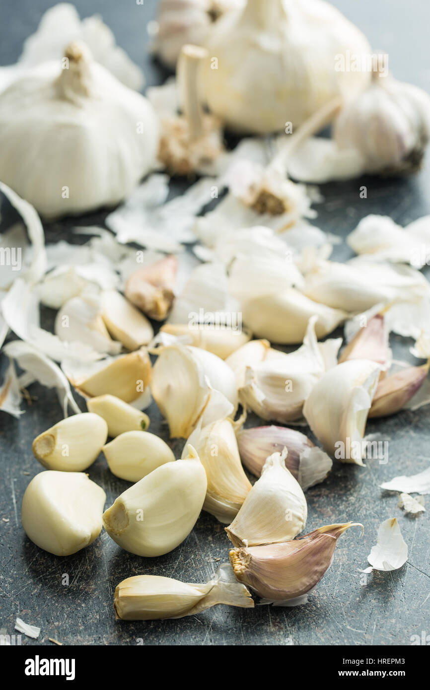 Peeled fresh garlic on kitchen table. Stock Photo