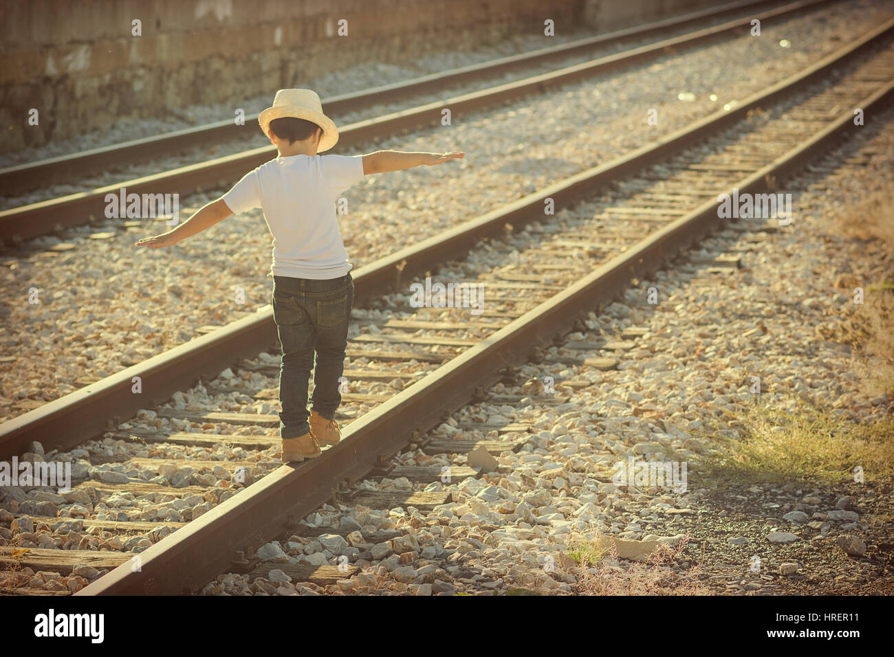 Child on the train tracks Stock Photo