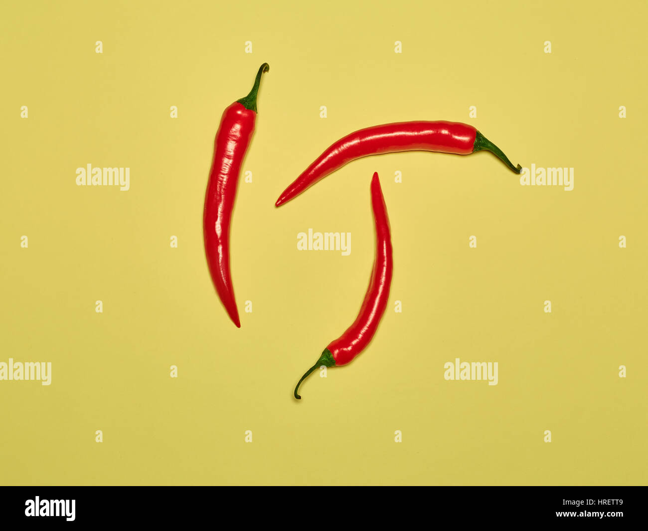 The bitter chili pepper and paprika on a yellow background Stock Photo