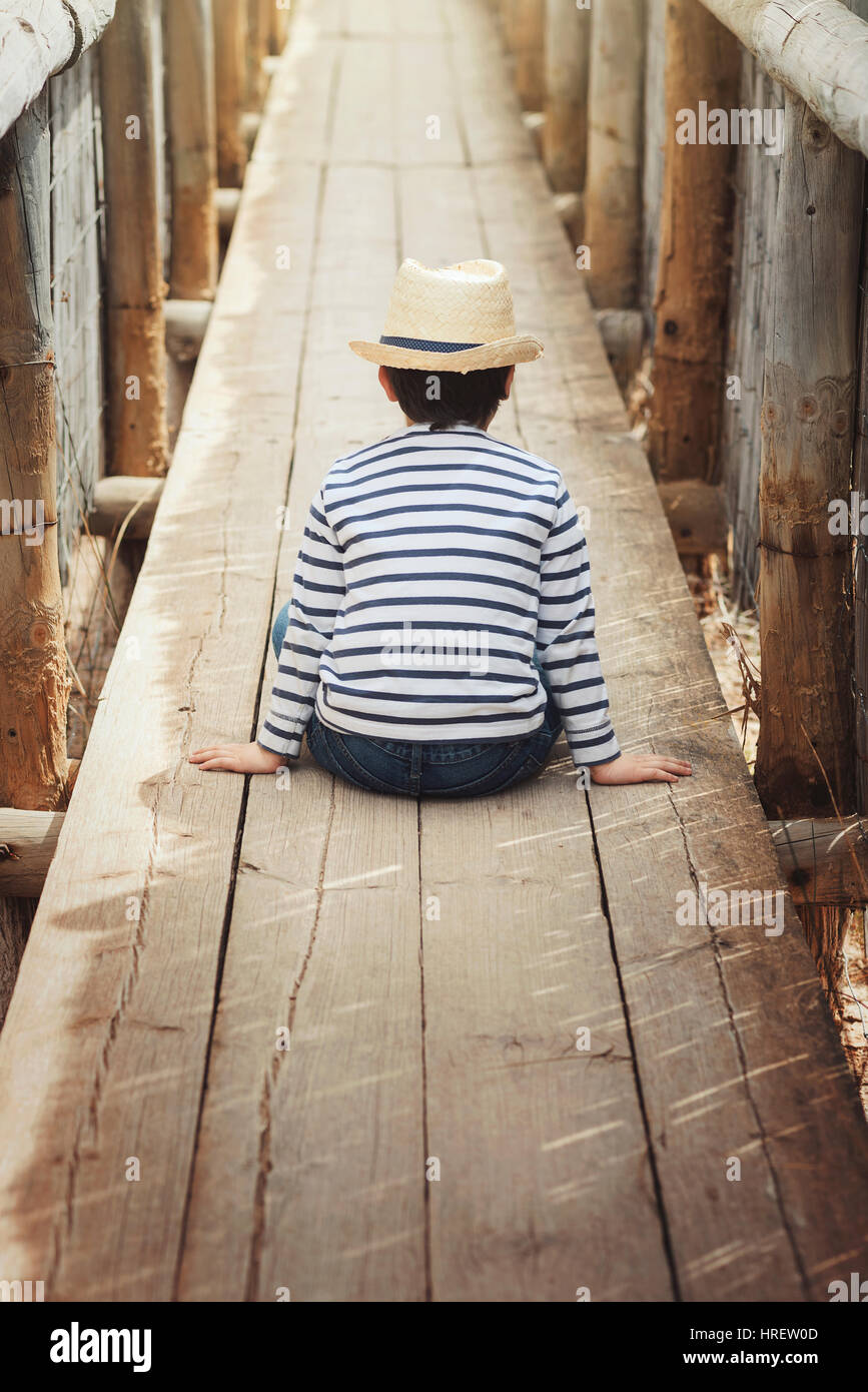 Little thoughtful boy, child outdoor portrait. Back view Stock Photo