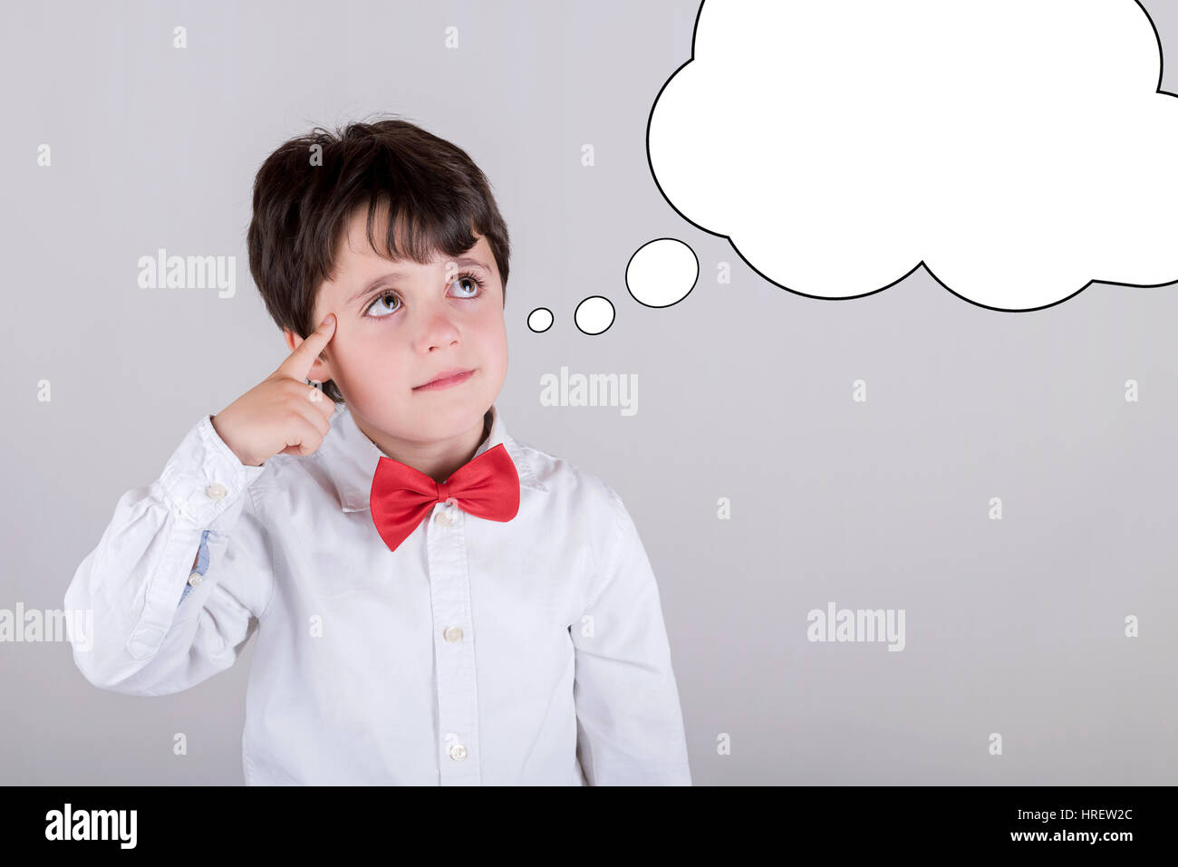 Thoughtful young boy with an empty thought bubble Stock Photo
