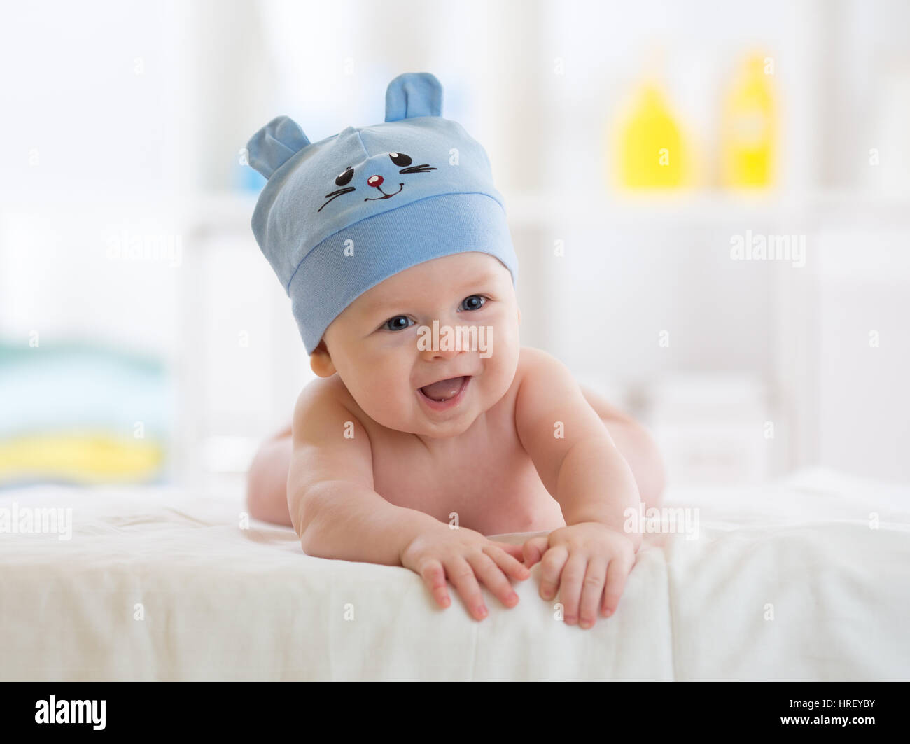 Portrait of a cute 5 months baby boy lying down on bed Stock Photo Alamy