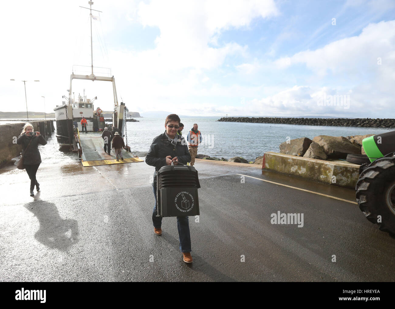 Senior presiding officer and polling station manager Teresa McCurdy arrives on Rathlin Island, off the north east coast of Northern Ireland, with the ballot box in which the island's population of just over 100 people will cast their votes during Thursday Assembly election. Stock Photo