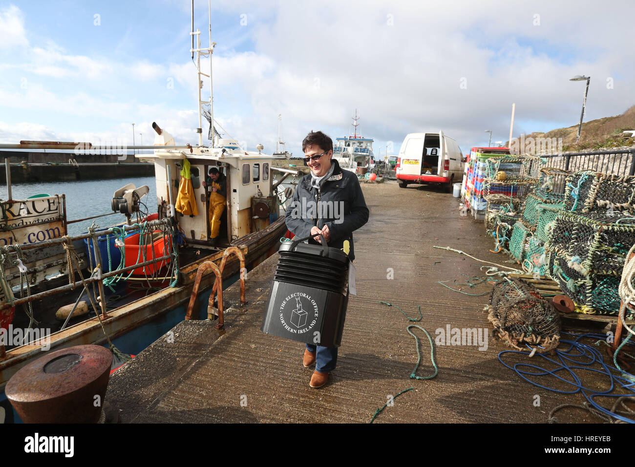 Senior presiding officer and polling station manager Teresa McCurdy arrives on Rathlin Island, off the north east coast of Northern Ireland, with the ballot box in which the island's population of just over 100 people will cast their votes during Thursday Assembly election. Stock Photo