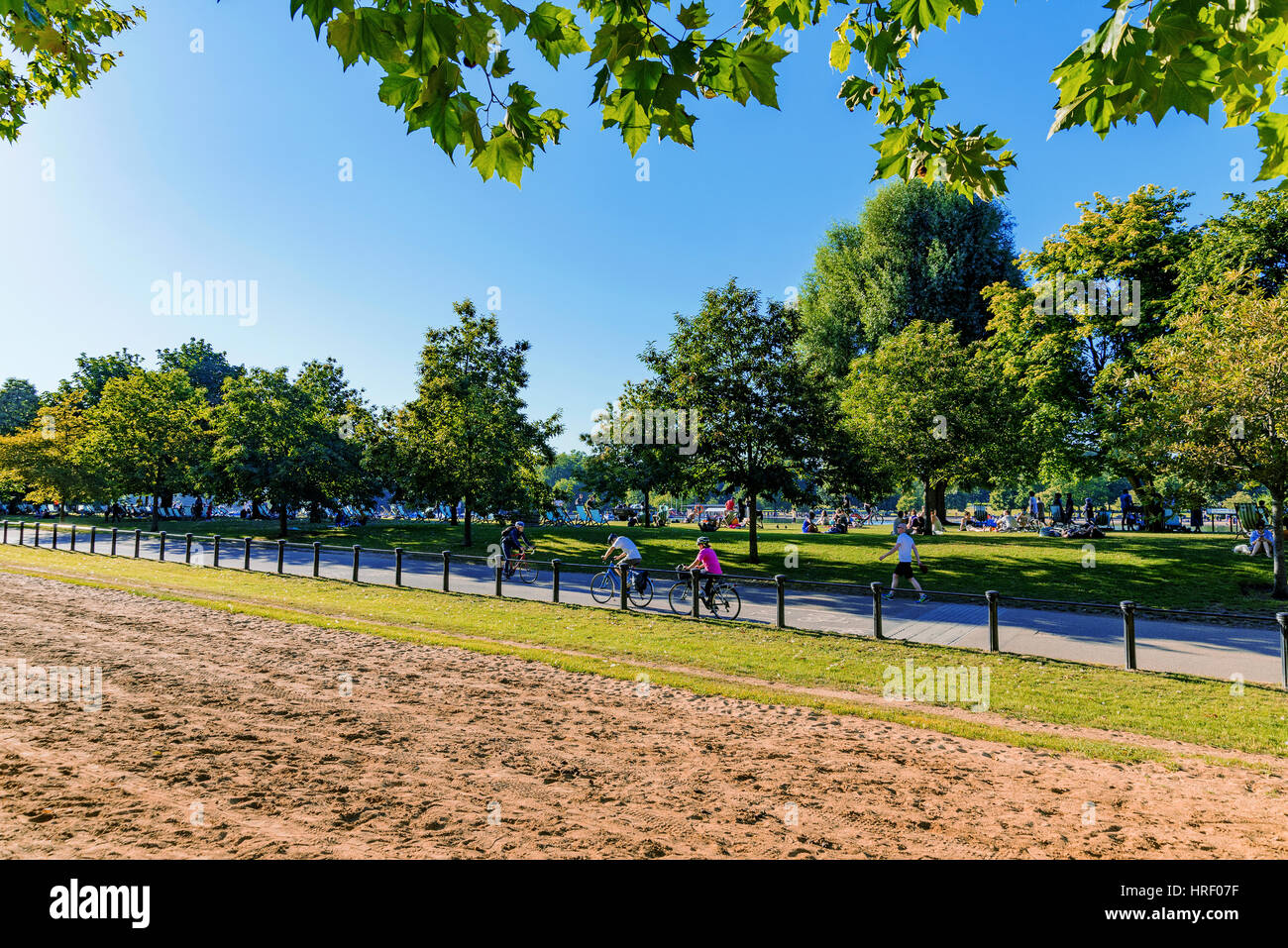 LONDON - JULY 19:  Hyde park is a famous London park. People are cycling on a hot day in the summer on July 19, 2016 in London Stock Photo