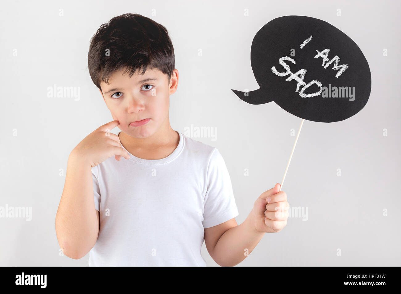 I am sad. Portrait of happy boy holding sign Stock Photo - Alamy