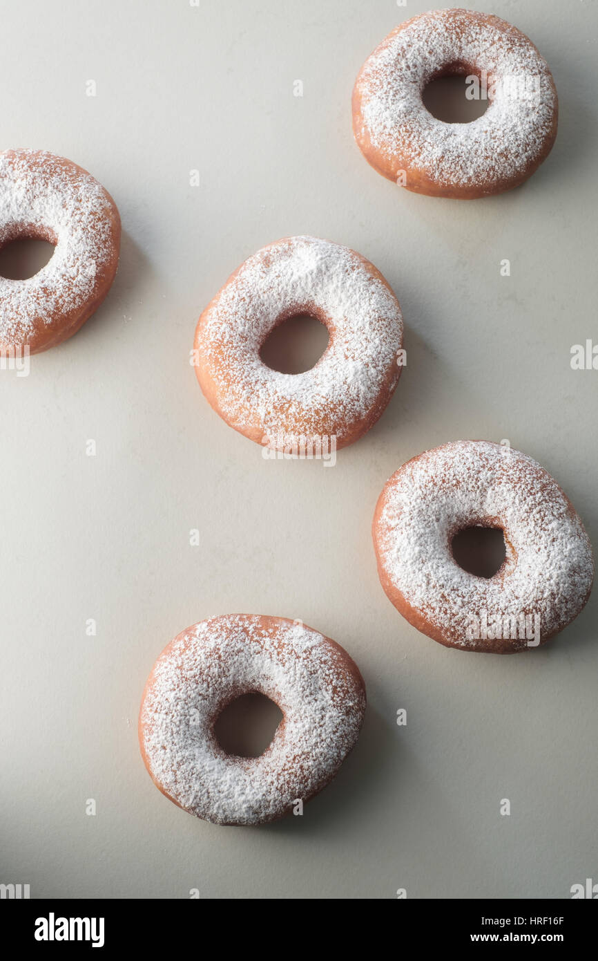 Powdered Sugar donuts on white table Stock Photo