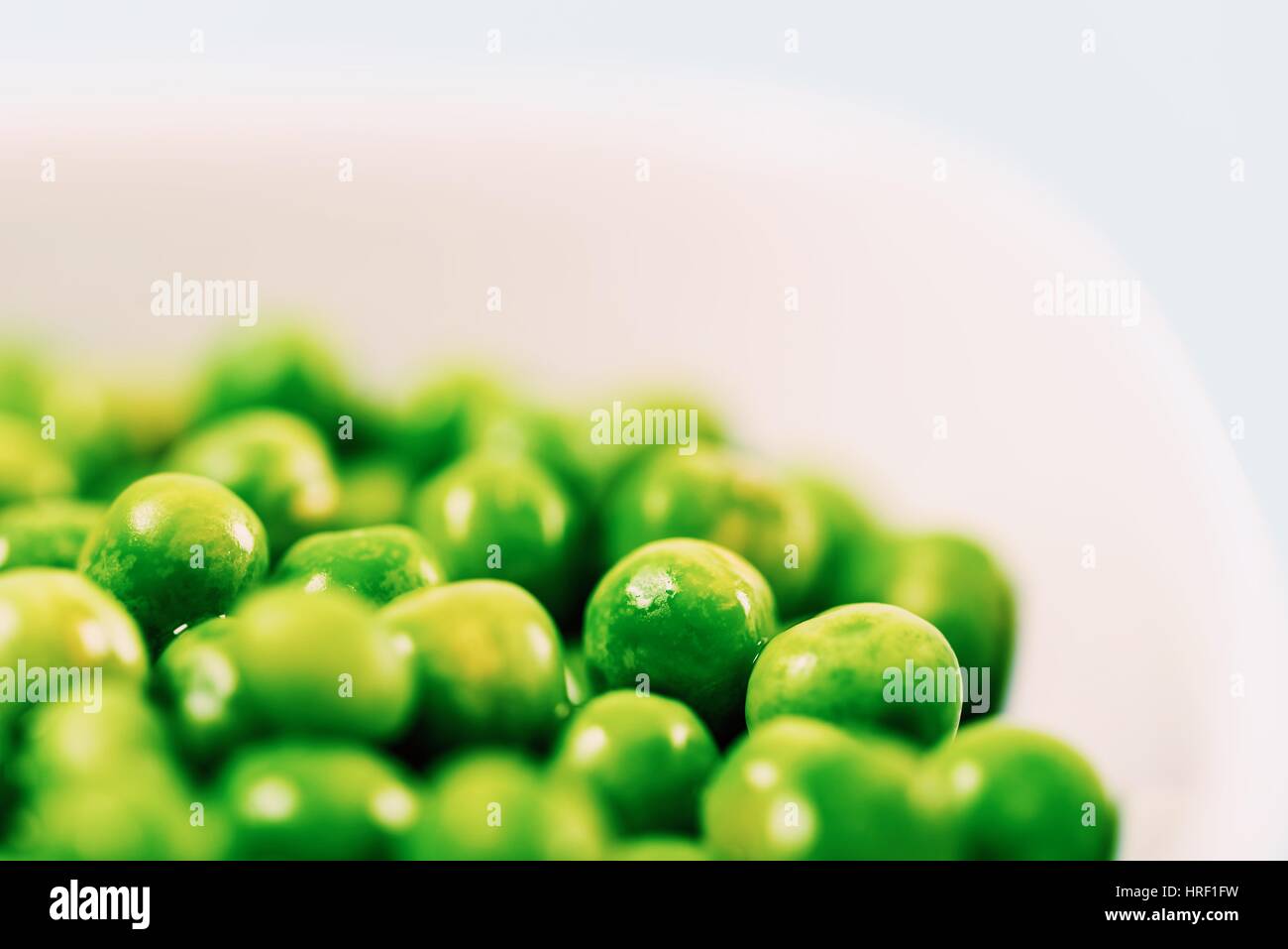 Fresh Green Peas In White Bowl On Turquoise Table Stock Photo