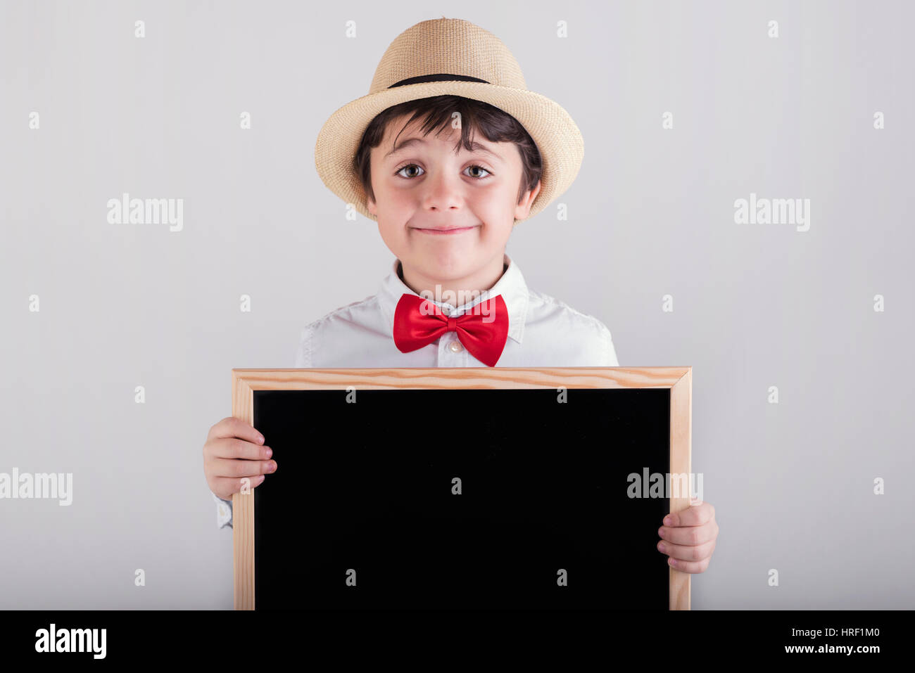 Happy child holding a blackboard Stock Photo