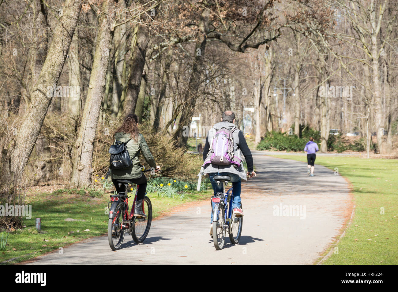 People cycling in a city park on a cold day. Tiergarten, Berlin, Germany Stock Photo
