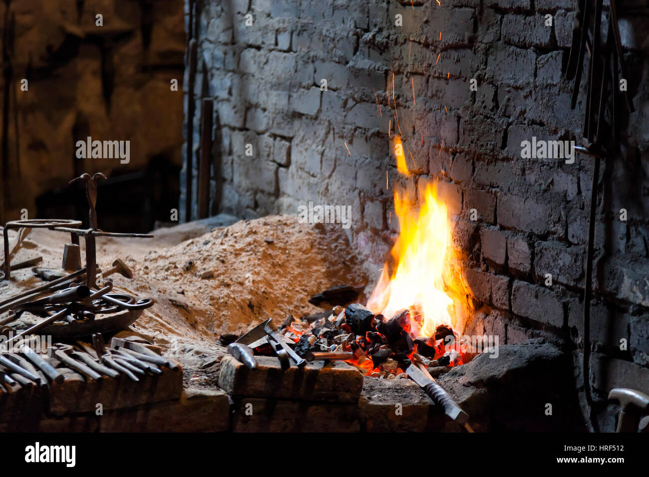 Fireplace in a blacksmith's forge, with some tools Stock Photo