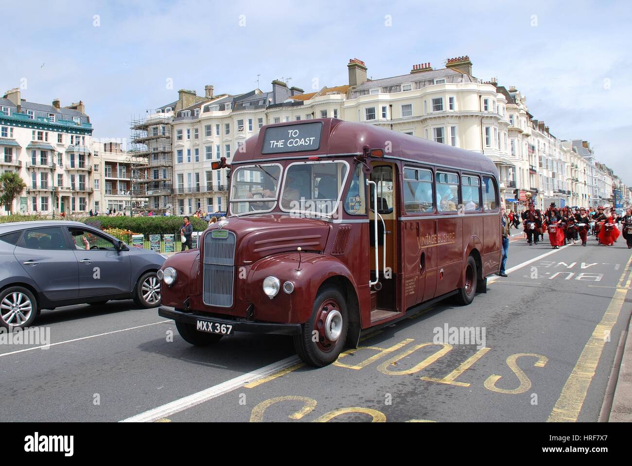 Guy Special vintage bus MXX367 leads a parade of drummers along the seafront at the annual St.Leonards Festival at St.Leonards-on-Sea, on July 7, 2016 Stock Photo