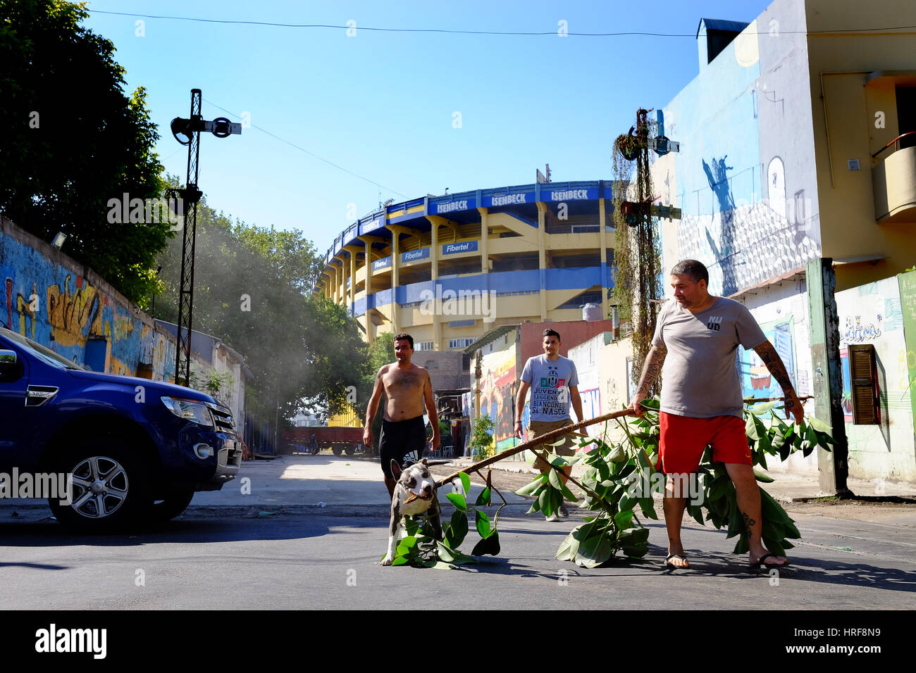 Man walking his dog in La Boca neighbourhood outside La Bombonera the home stadium of Boca Juniors of Buenos Aires, Argentina. Picture by SAM BAGNALL Stock Photo