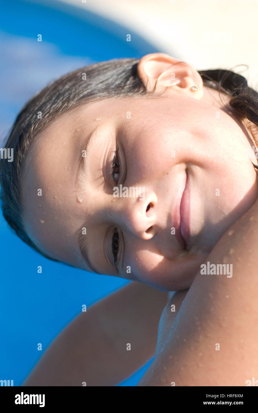 Young girl 10 years old, playing on the swimming pool Stock Photo