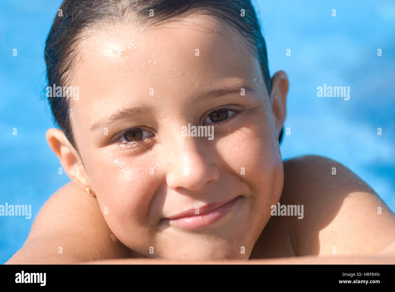 Young girl 10 years old, playing on the swimming pool Stock Photo
