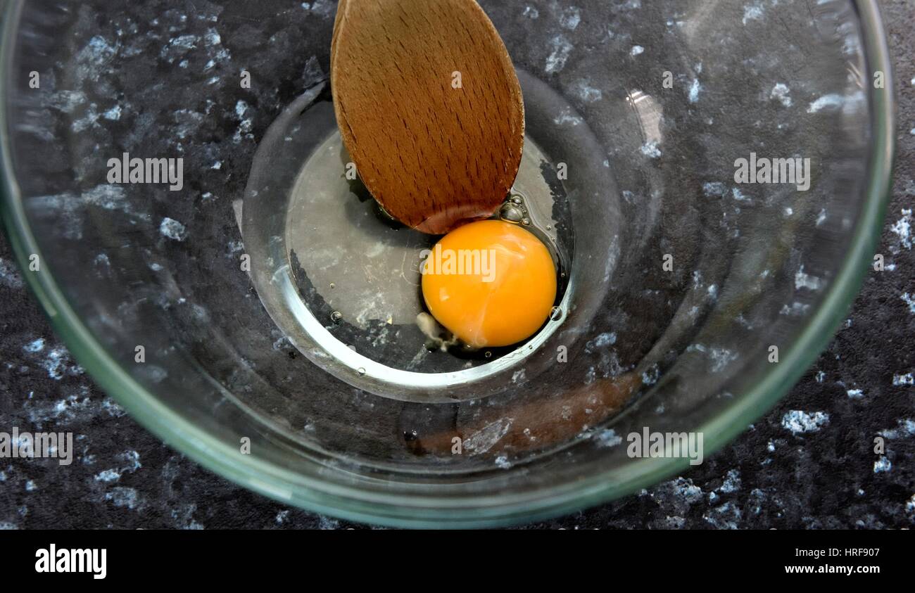 Raw egg in a mixing dish Stock Photo Alamy