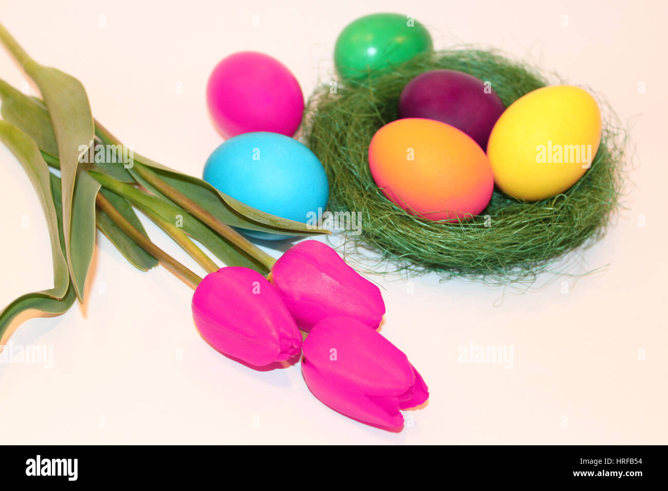Colored easter eggs and violet tulips on white background Stock Photo ...