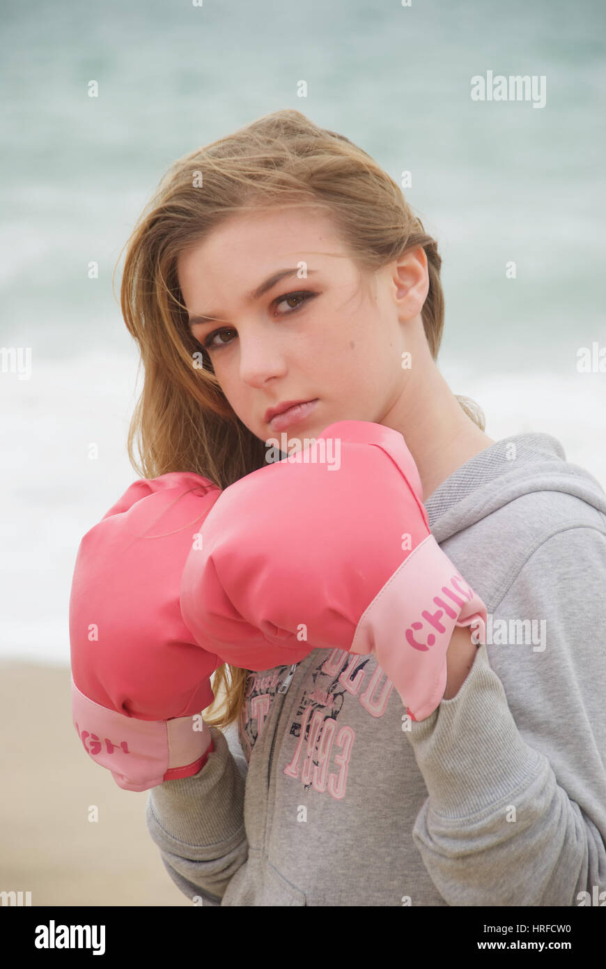 Pretty teenage girl on the beach wearing boxing gloves Stock Photo Alamy