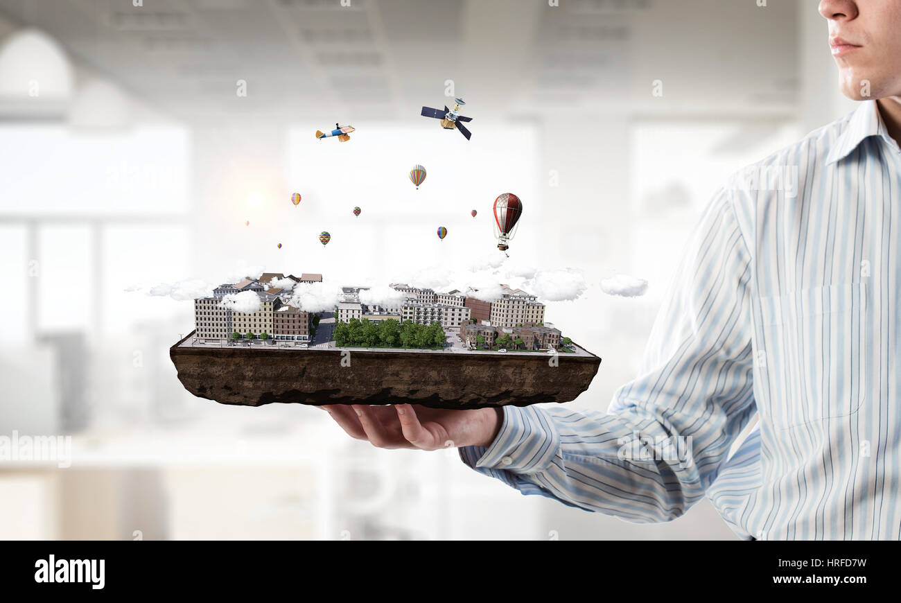 Close up of businessman hand holding construction model. Mixed media ...