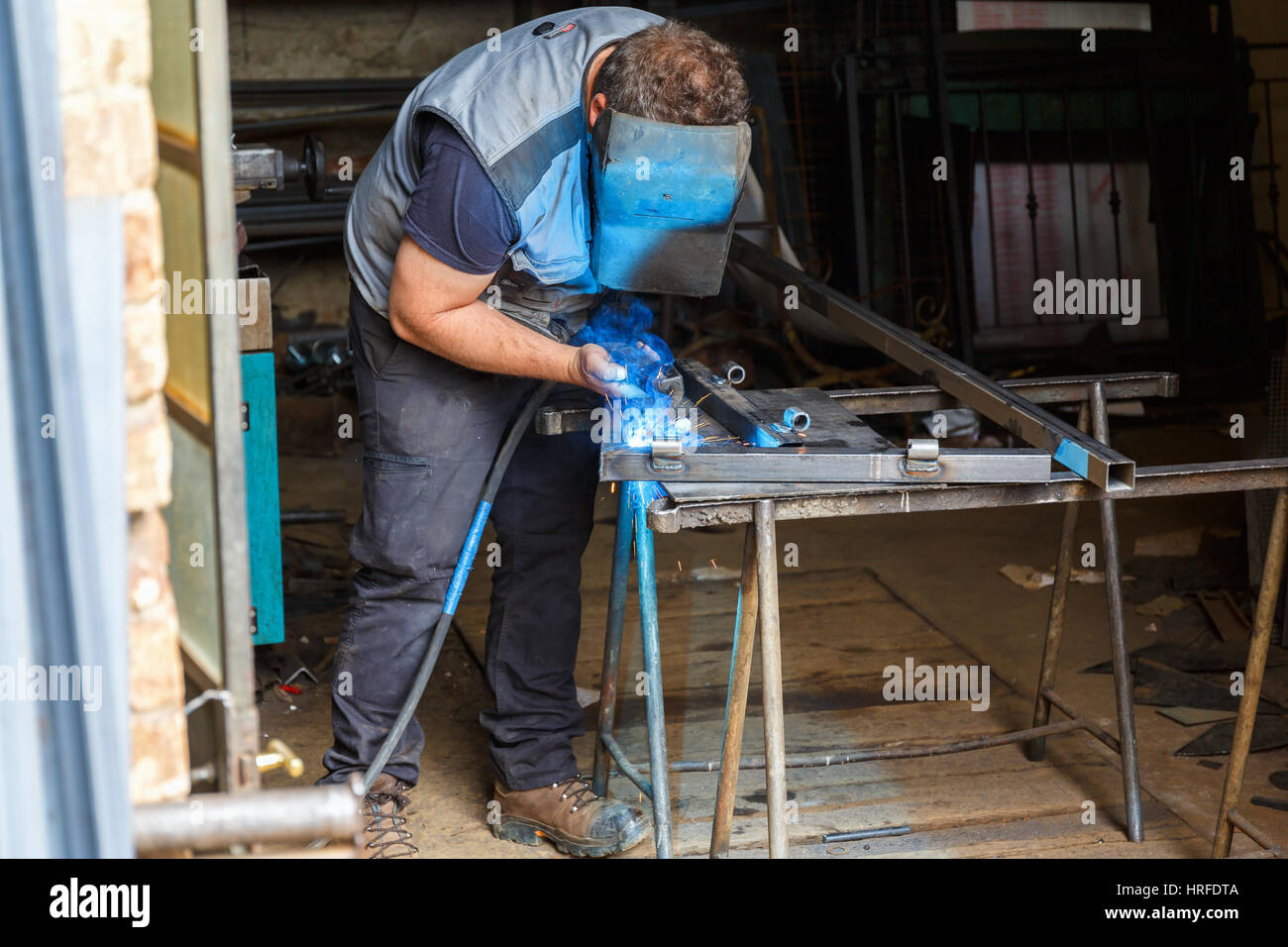 Welding work performed by a man in a workshop Stock Photo
