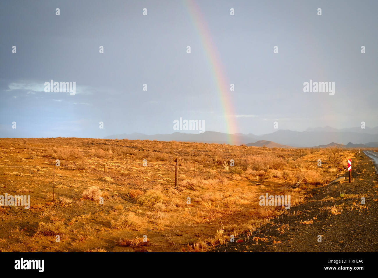 A rainbow over the Karoo desert near Prince Albert, South Africa, after a rain storm Stock Photo