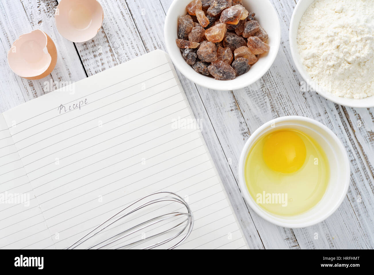 Note book and ingredients for baking on a wooden background Stock Photo