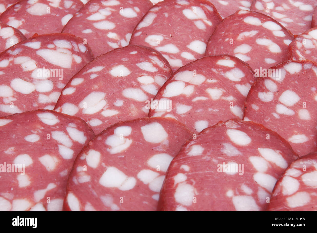 Salami background with many sliced pieces of salami Stock Photo - Alamy