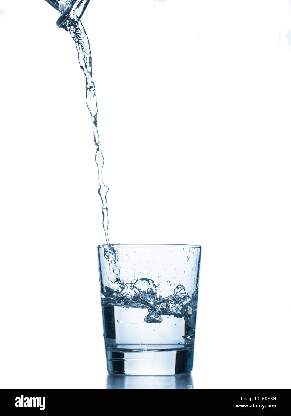 Water poured into glass. Isolated on white background Stock Photo Alamy