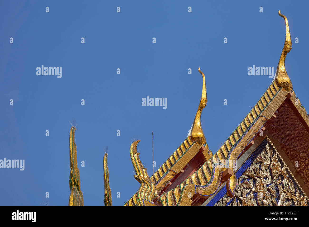 Ornamented multiple roof tiers of a Thai temple (wat), decorated with naga style heads - Bangkok, Thailand Stock Photo