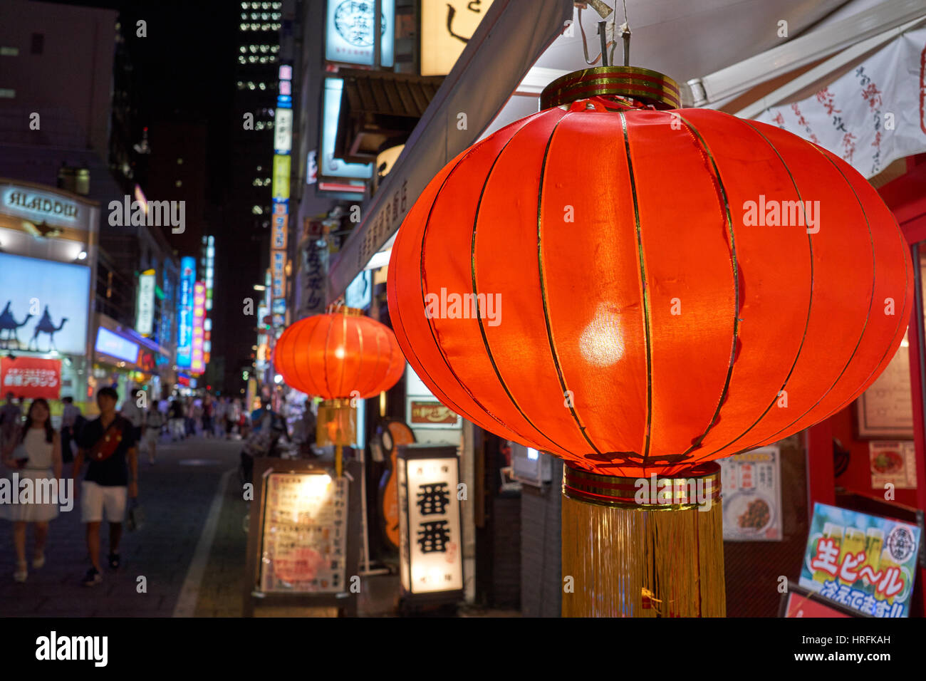 Red lanterns at night in front of a restaurant in busy Shibuya, downtown Tokyo, Japan Stock Photo