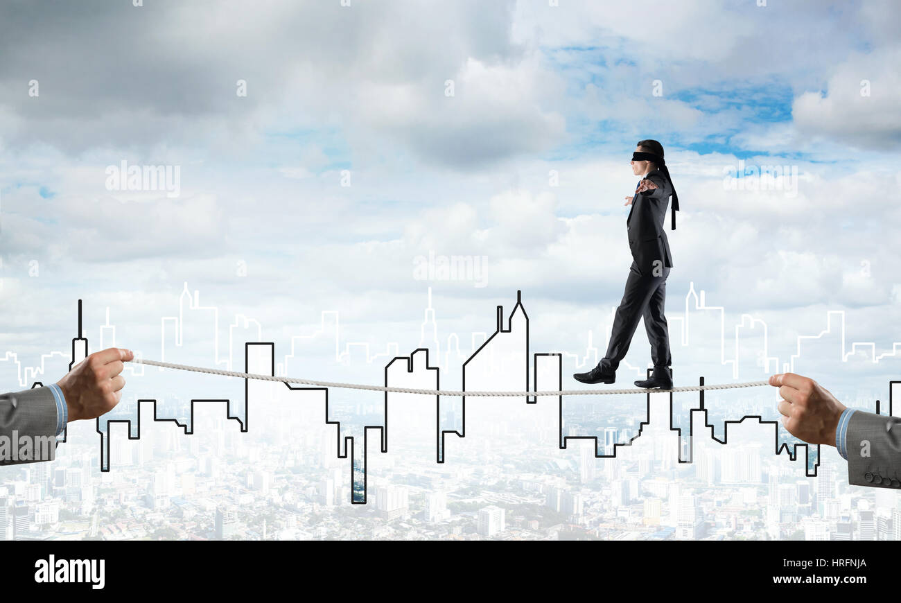 Business concept of risk support and assistance with man balancing on ...