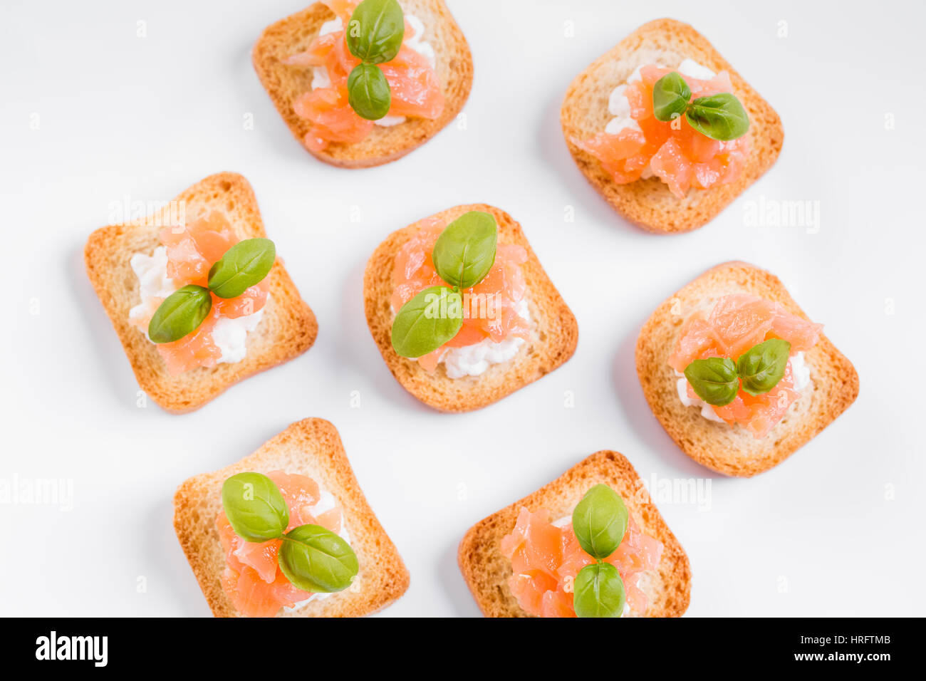 Canapes with smoked salmon, cream cheese and basil Stock Photo