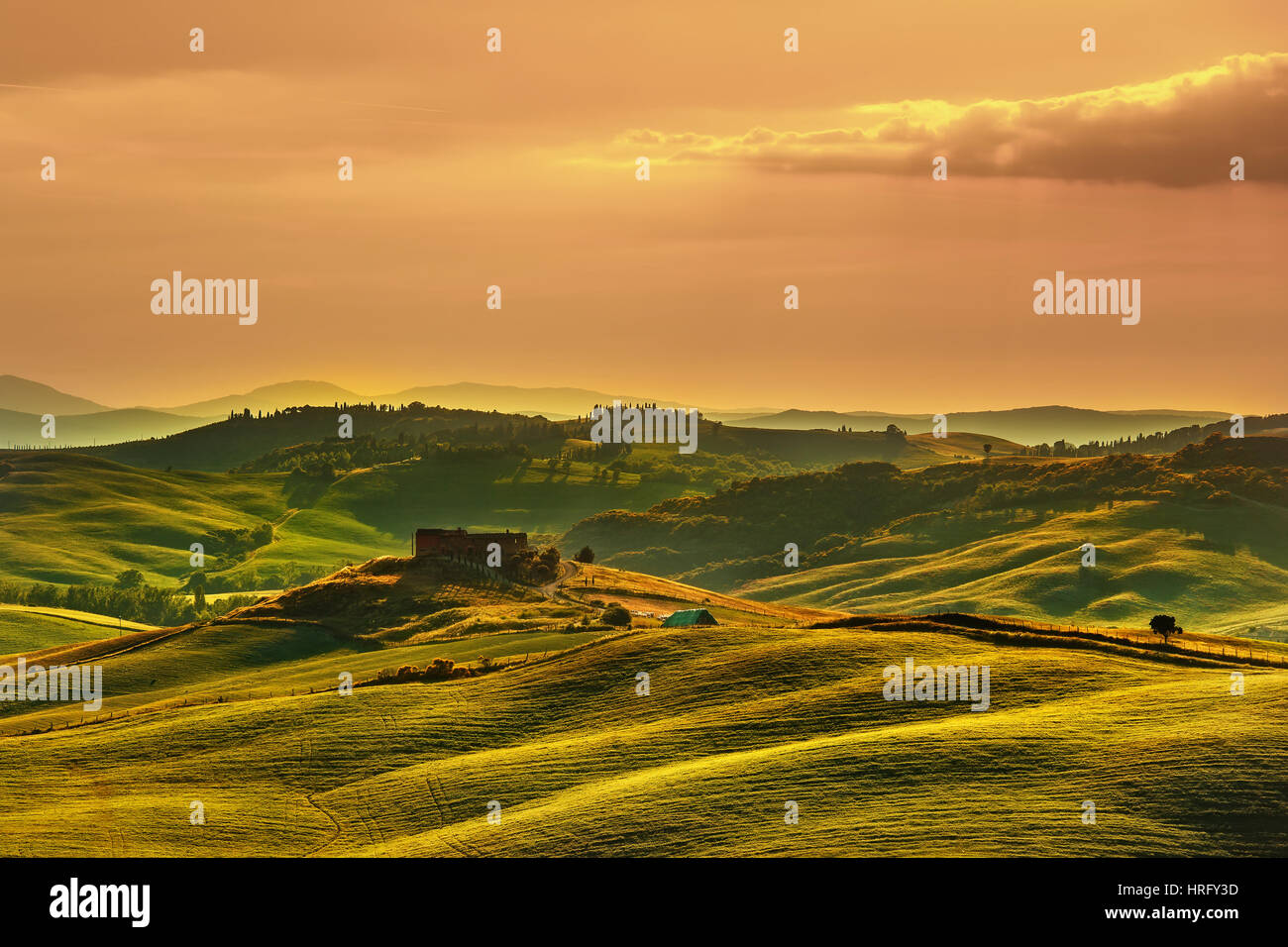 Tuscany spring, rolling hills on sunset. Volterra rural landscape. Green fields and farmland. Italy, Europe Stock Photo