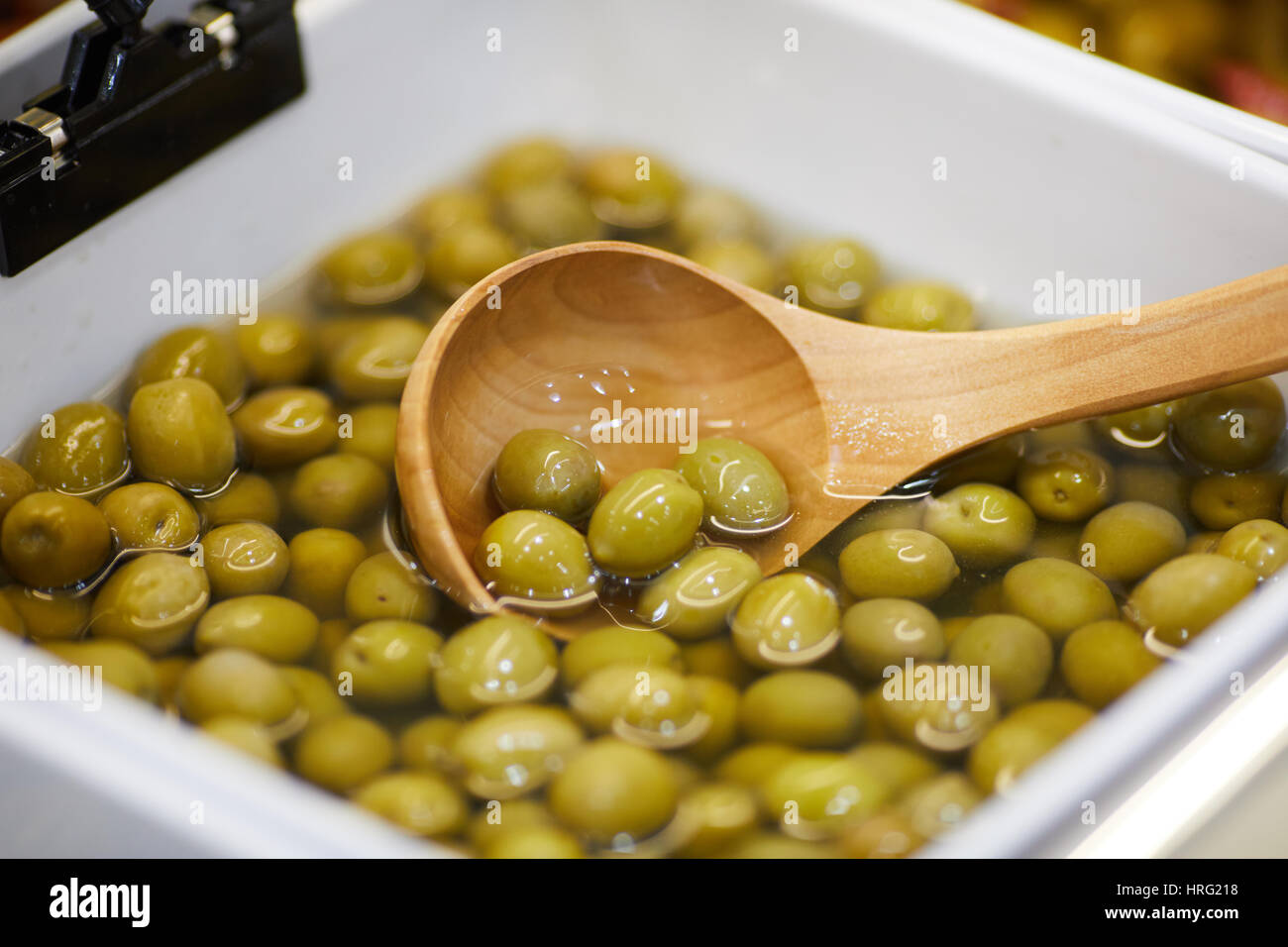 Green Olives in water ready to eat. Stock Photo