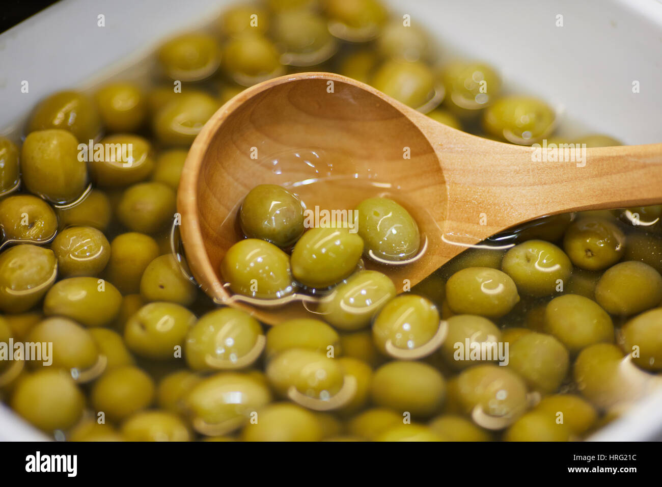 Green Olives in water ready to eat. Stock Photo