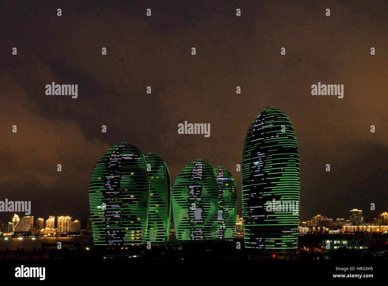 Phoenix Island Resort and apartment complex in Sanya harbour, China during the famous integrated LED screen light show every night. Stock Photo