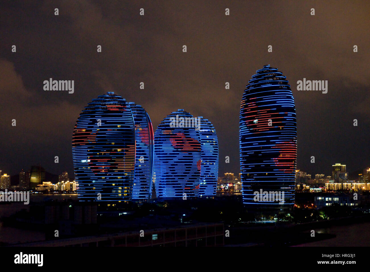 Phoenix Island Resort and apartment complex in Sanya harbour, China during the famous integrated LED screen light show every night. Stock Photo