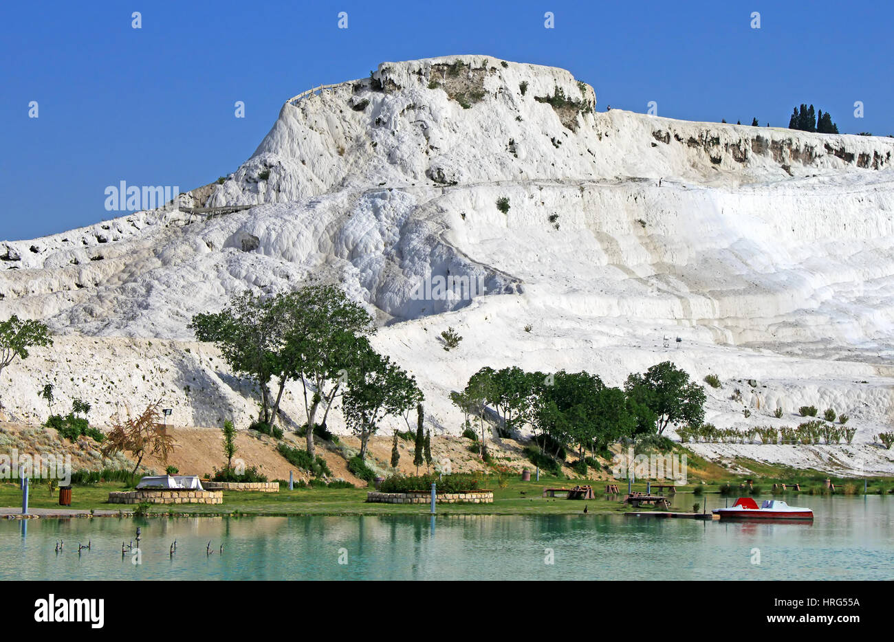 Lake and calcified limestone terraces on background, Pamukkale, Turkey Stock Photo