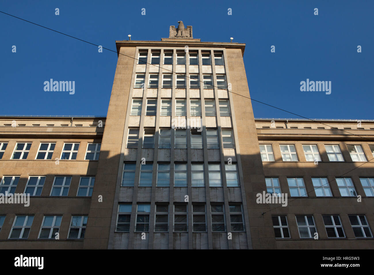 Nazi Reichsadler topped the office building from the Nazi era in Friedrichstraße in Berlin, Germany. The building designed by German architect Hans Fritzschez was built in 1938-1940. It was used as the department of the Reichsarbeitsministerium (Nazi German Ministry of Labor) and the Organisation Todt, now served as the Bundesagentur fur Arbeit (Unemployment Office). Stock Photo