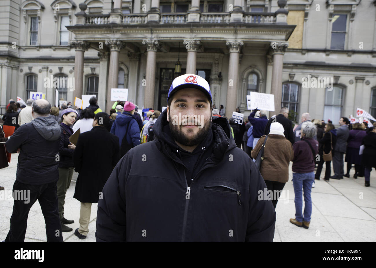 Trenton, New Jersey, USA. 27th Feb, 2017. NICK RUGGIA, 30, of a media freelancer of Jersey City, New Jersey expressed his concern for the Affordable Cares Act that may be repealed during a rally at the Statehouse in Trenton, New Jersey. Ruggia suffers from obsessive compulsive disorder, also known as, OCD. "For the last four years"" he has been "ACA related health programs."" "Having access through medication has allowed me to lead a productive, interesting and fun life."" "If you take away our access to health care you are literally threatening our basic existence"" said Ru Stock Photo