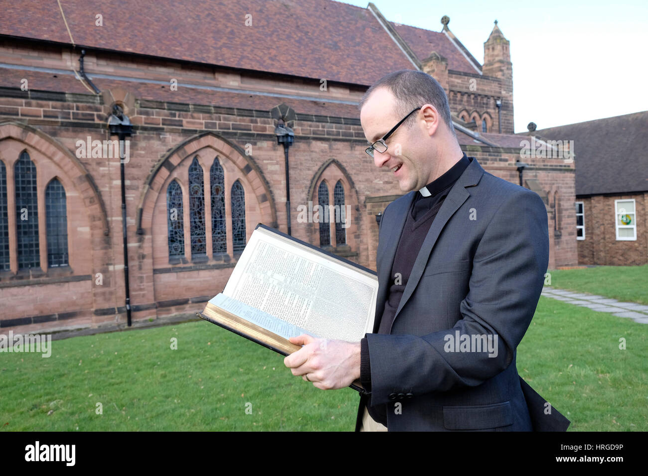 Prenton Wirral, UK. 2nd Mar, 2017. Rev Matt Graham, Vicar of St Stephen's Church, Prenton holds The Holy Bible, his favourite book and one of the worlds most famous books, on World Book Day. Credit: GeoPic/Alamy Live News Stock Photo