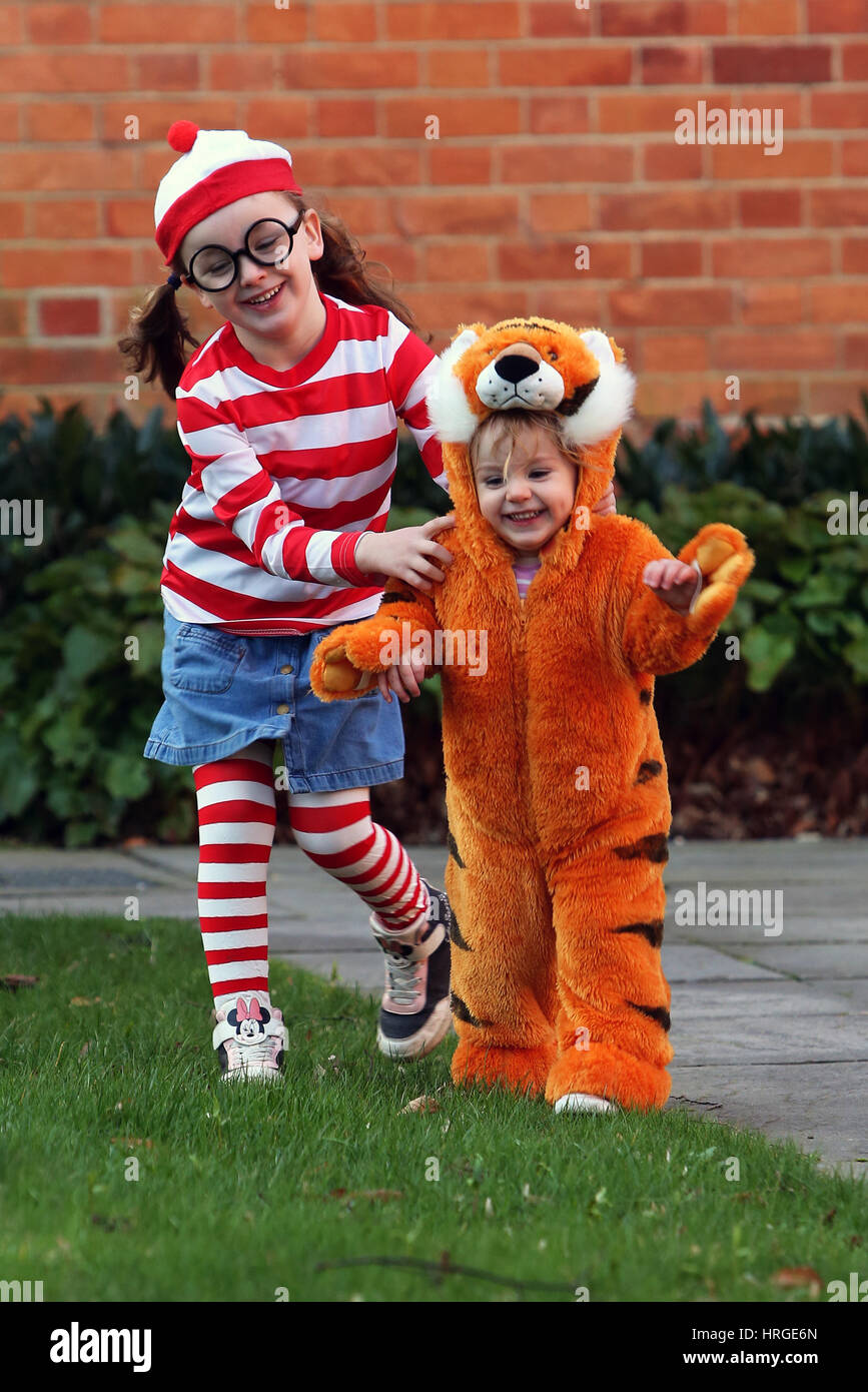 Chichester, UK. 2nd March 2017. Isabelle, 5, and her sister Florence, 1, pictured on their way to school and nursery dressed up as Where's Wanda and The Tiger Who Came To Tea for World Book Day 2017. Sam Stephenson/Alamy Live News. Credit: Sam Stephenson/Alamy Live News Stock Photo