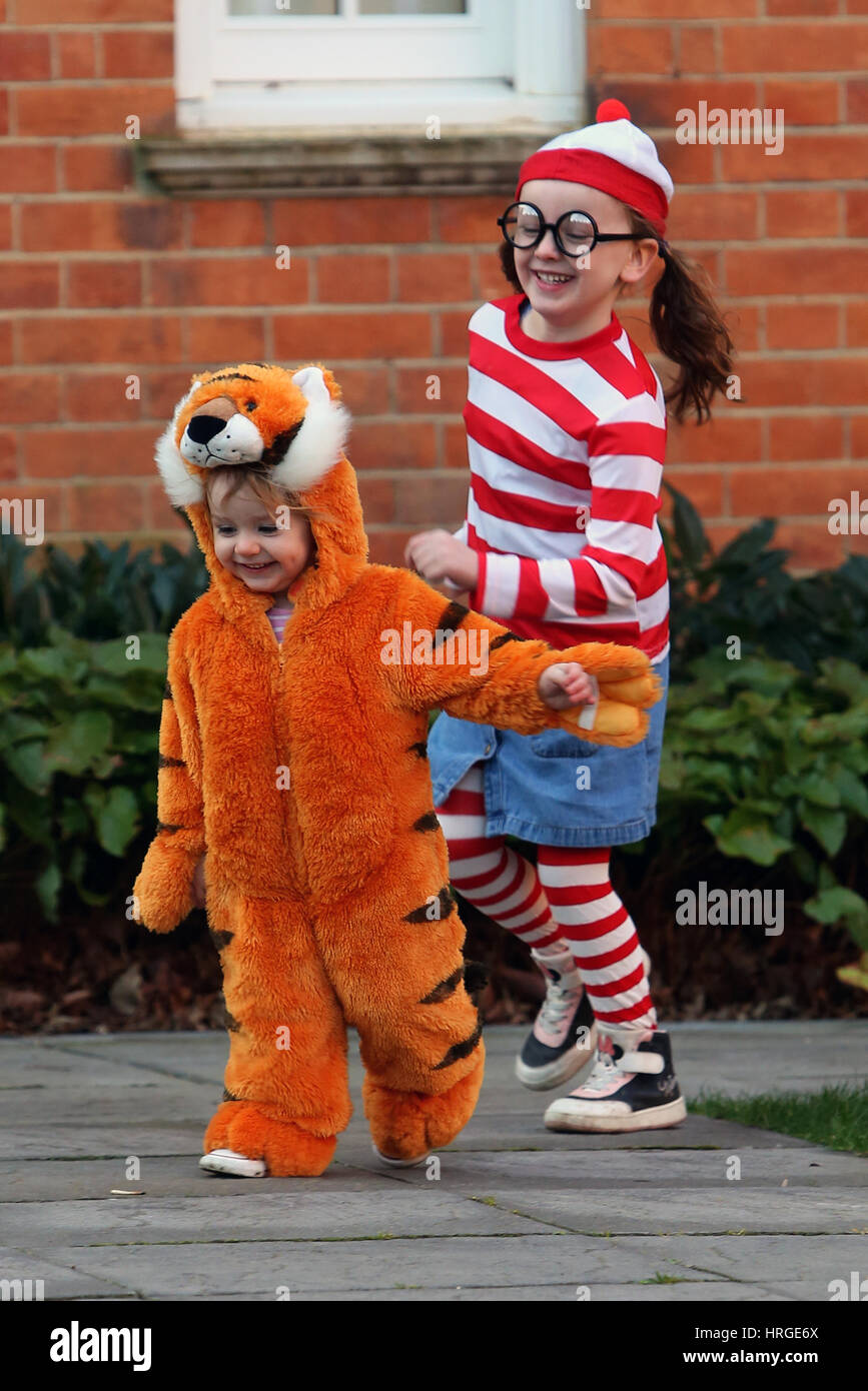 Chichester, UK. 2nd March 2017. Isabelle, 5, and her sister Florence, 1, pictured on their way to school and nursery dressed up as Where's Wanda and The Tiger Who Came To Tea for World Book Day 2017. Sam Stephenson/Alamy Live News. Credit: Sam Stephenson/Alamy Live News Stock Photo