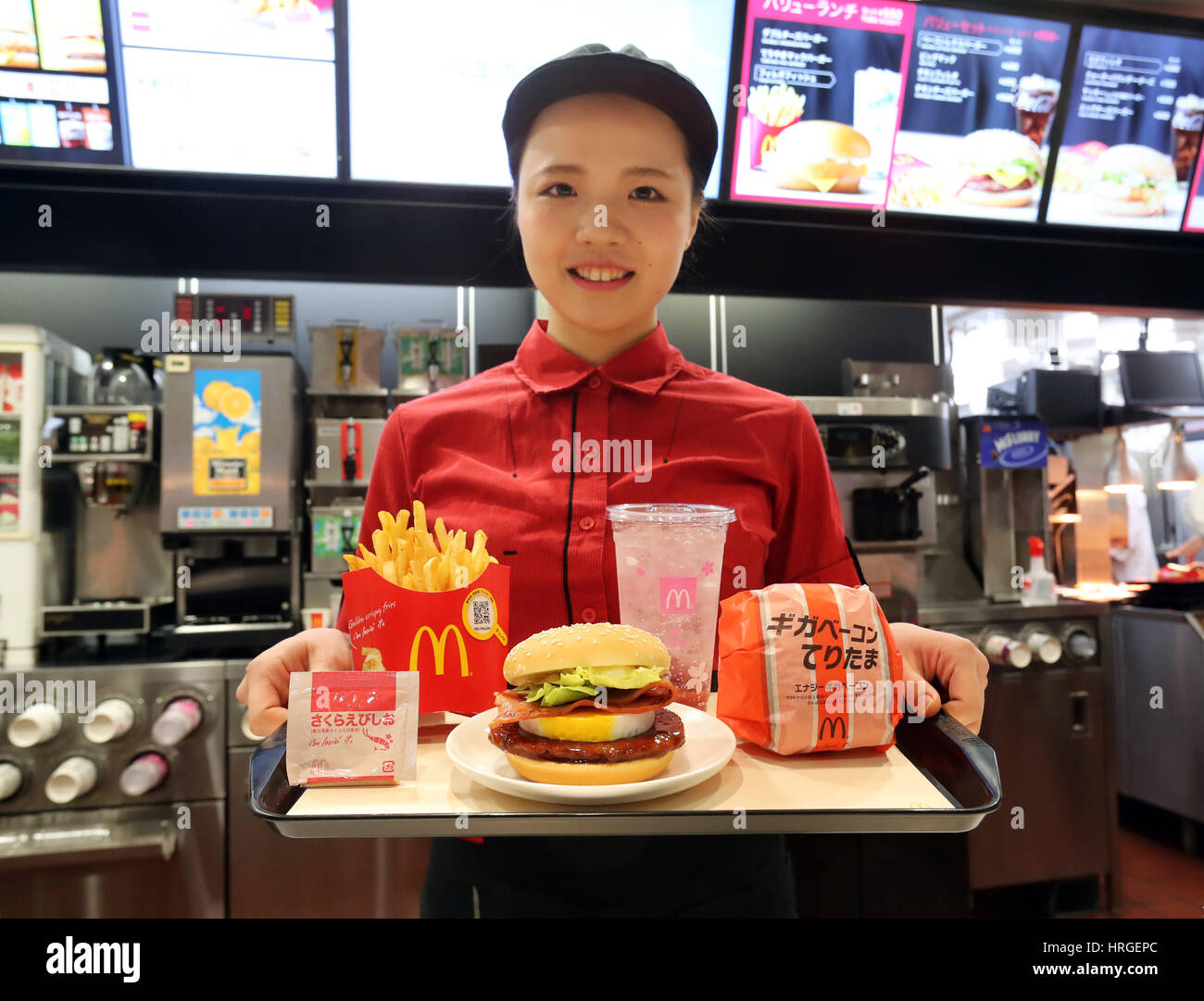 Tokyo, Japan. 2nd Mar, 2017. An employee of McDonald's Japan displays the new burger "Giga bacon