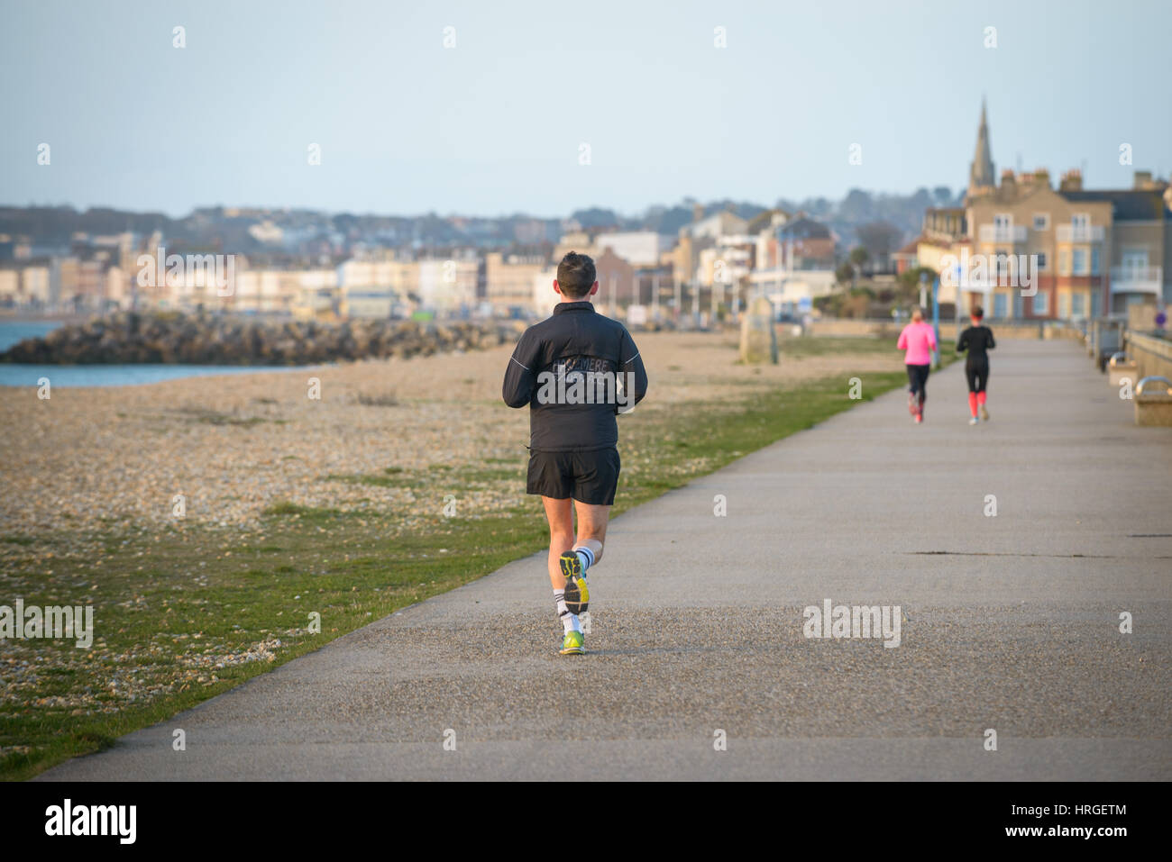 Weymouth Bay, Dorset, UK. 2nd March, 2017. Joggers along the promenade on a fine clear morning at Weymouth Bay, the first fine day of spring. © Dan Tucker/Alamy Live News Stock Photo