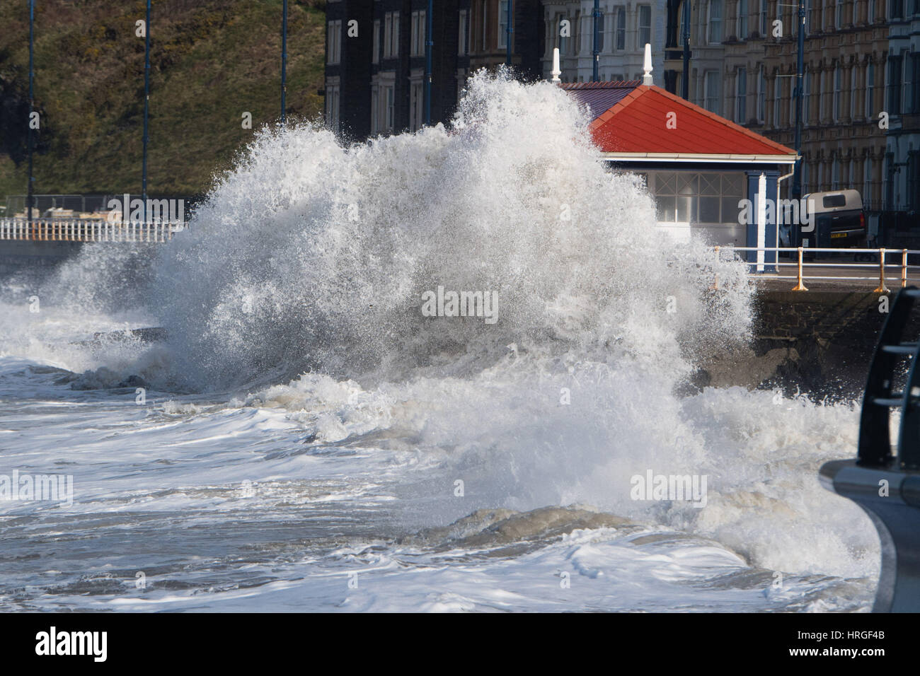 Aberystwyth, Wales, UK. 2nd March 2017.  UK Weather: After a night of gale force winds, thunderstorms and hailstones,  the morning’s 5.4m high spring tide bring mountainous high waves to batter the promenade and sea defences in Aberystwyth  on the Cardigan Bay coast of West Wales    Credit: keith morris/Alamy Live News Stock Photo