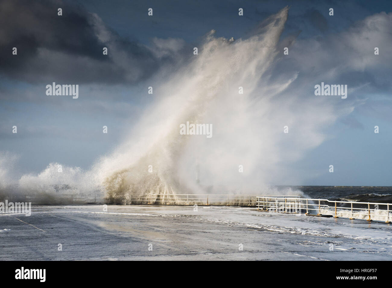 Aberystwyth, Wales, UK. 2nd March 2017. UK Weather: After a night of gale force winds, thunderstorms and hailstones, the morning's 5.4m high spring tide bring mountainous high waves to batter the promenade and sea defences in Aberystwyth on the Cardigan Bay coast of West Wales photo Credit: Keith Morris/Alamy Live News Stock Photo