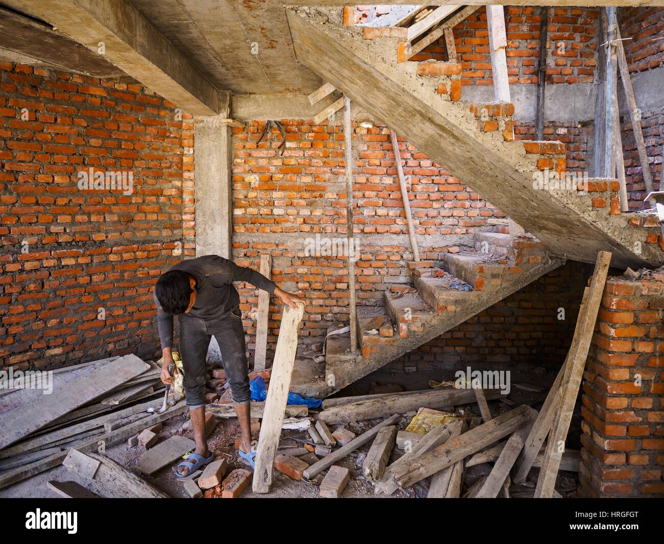Sankhu, Central Development Region, Nepal. 2nd Mar, 2017. A construction worker scavenges wood for a home he is working in Sankhu. Many of the homes are being rebuilt with materials scavenged from buildings destroyed in the 2015 earthquake, There is more construction and rebuilding going on in Sankhu, west of central Kathmandu, than in many other parts of the Kathmandu Valley nearly two years after the earthquake of 25 April 2015 that devastated Nepal. In some villages in the Kathmandu valley workers are working by hand to remove ruble and dig out destroyed buildings. About 9,000 people were Stock Photo