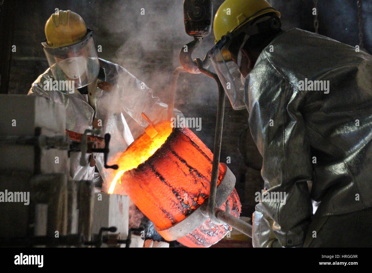 New York, USA. 24th Feb, 2017. Workers pour liquid bronze that has ...