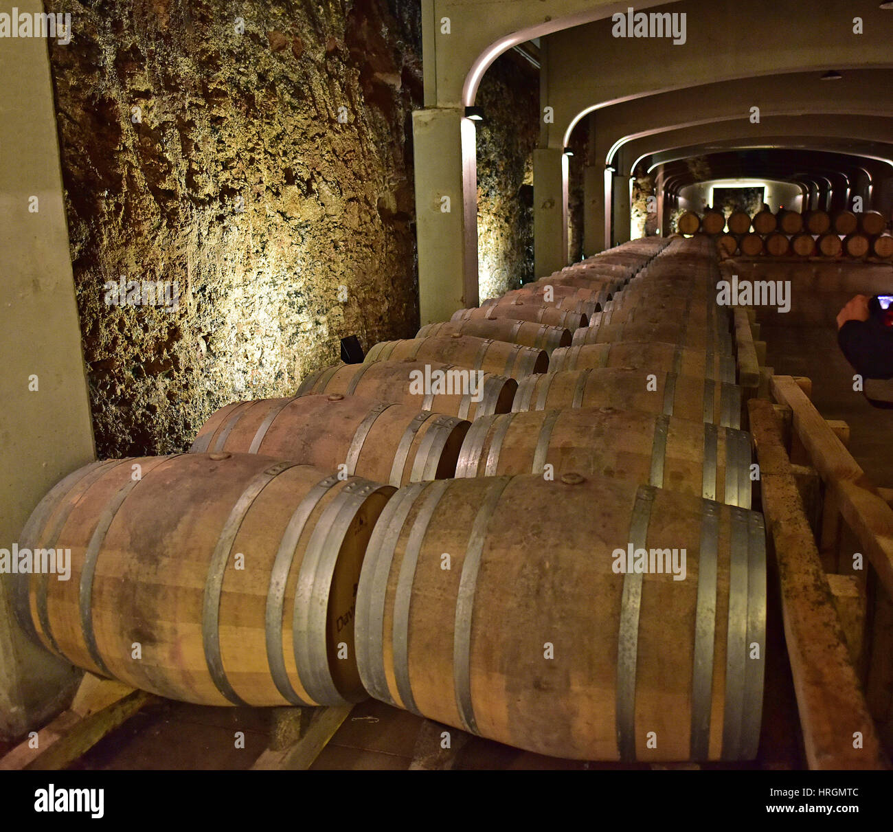 Wooden barrels in winery cellar. Stock Photo